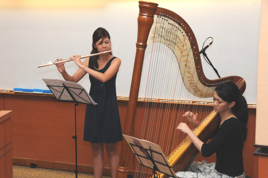 Musical interlude: (From left) Kelly LOH (flute), Mifiona QUAH (harp)  <i class="fas fa-video"></i>