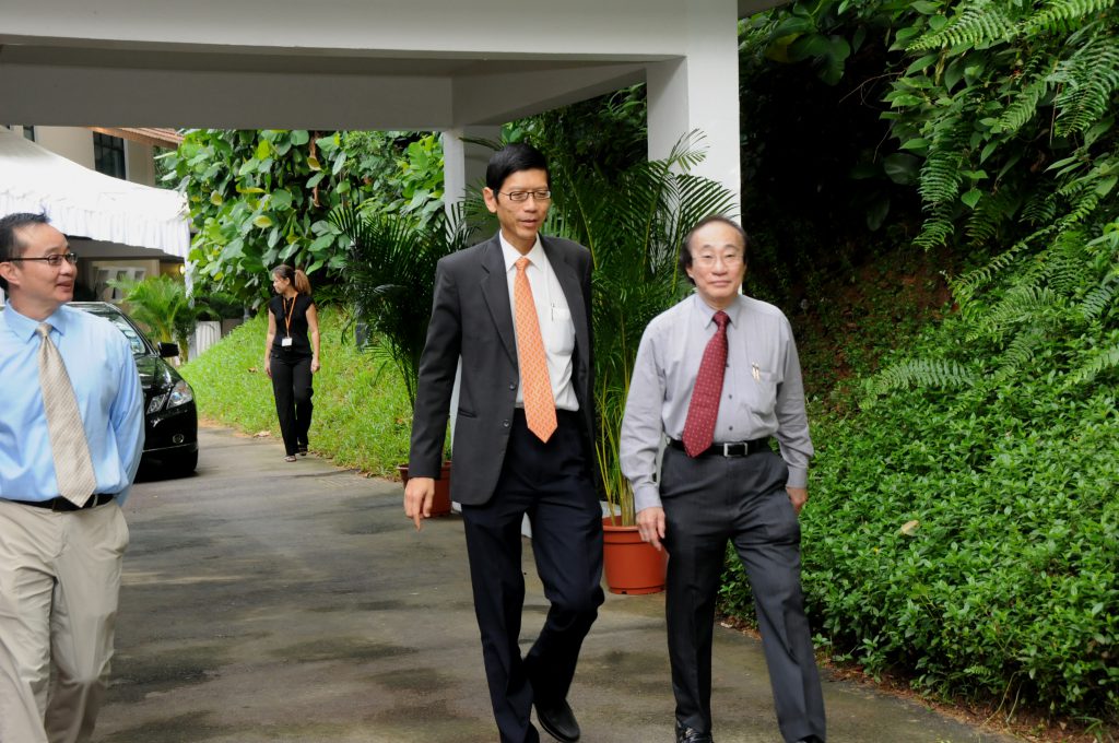 Striding towards the future: President TAN Chorh Chuan flanked by Director and Deputy Director